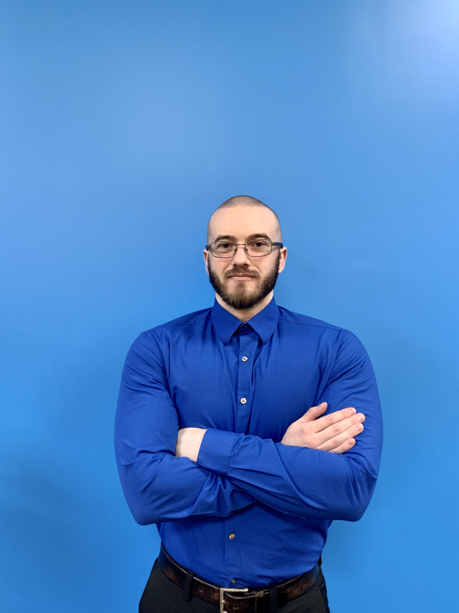 Alexander Panas club manager at Fitness Connection - man standing in front of a blue background
