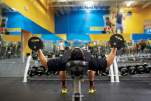 Man using free weights to train at Fitness Connection