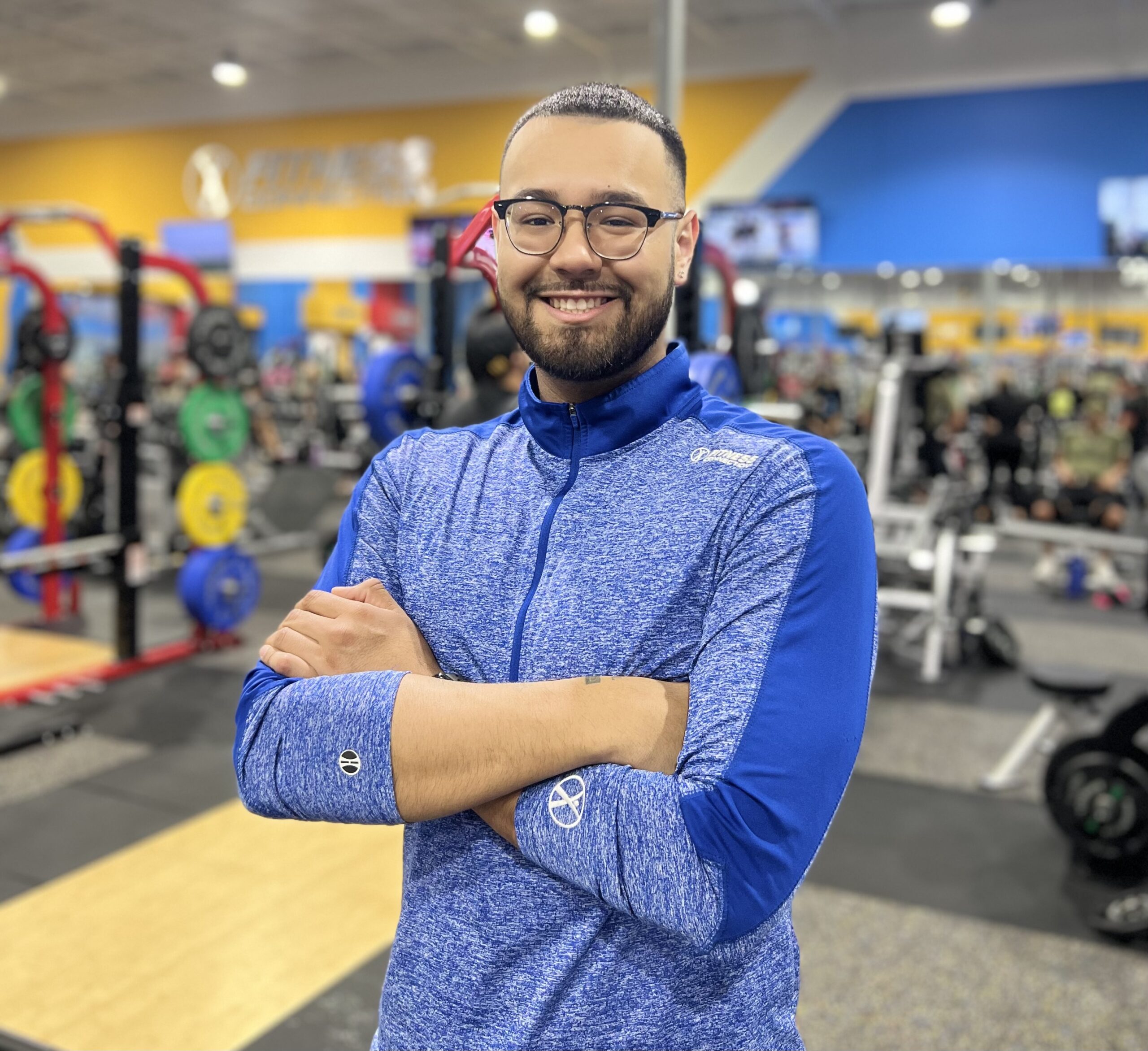 Jose H. - Club Manager of Fitness Connection standing in front of fitness equipment